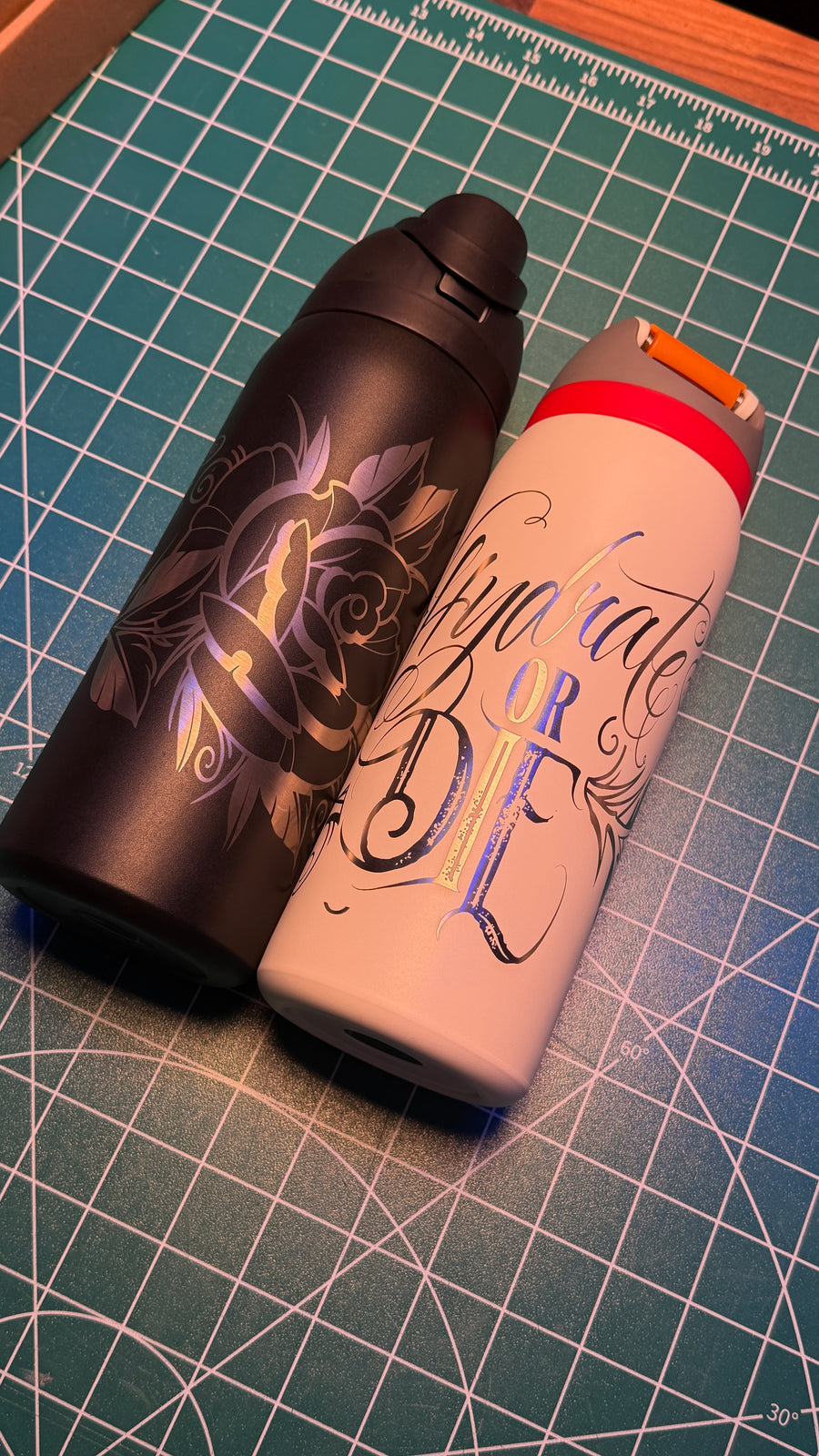 Black and white water bottle examples showing artwork; sold individually